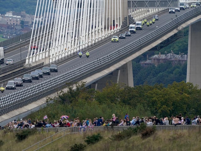 The hearse carrying the coffin of Queen Elizabeth II, draped with the Royal Standard of Scotland, passing over the Queensferry Crossing as it continues its journey to Edinburgh from Balmoral. Picture date: Sunday September 11, 2022.