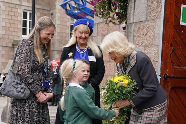 The Queen Consort is given a posy of flowers as she attends the in Ballater. (Photo: Andrew Milligan/PA Wire)