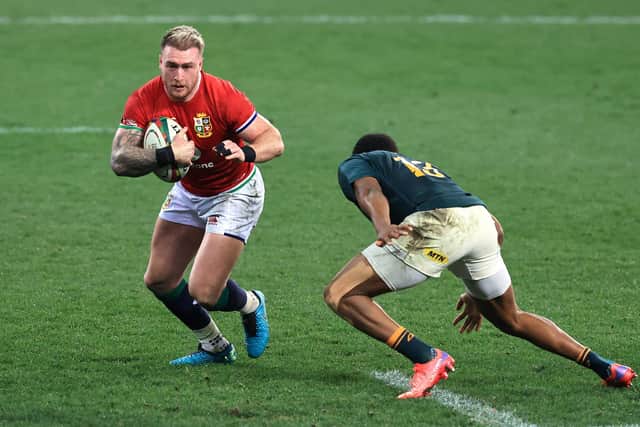 Stuart Hogg takes on Lukhanyo Am of South Africa during the second Lions Test in Cape Town. (Photo by David Rogers/Getty Images)