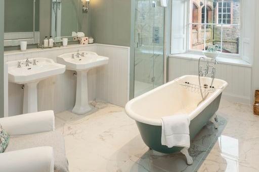 The spacious bathroom in The Sculleries suite includes the free-standing roll-top bath.