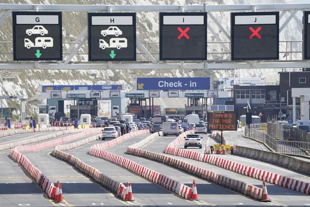 Cars queue at the check-in at the Port of Dover in Kent. Authorities have worked "around the clock" to clear both freight and tourist traffic in Dover, the port said. Some 72,000 passengers - more than 200 miles of tourist and freight traffic combined - had been processed by Sunday morning. Picture date: Sunday July 24, 2022.