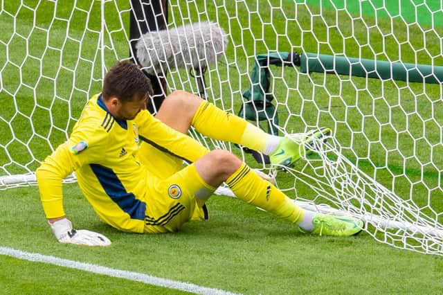 David Marshall untangles himself from the net after being beaten by Patrick Schick's long-range lob. (Photo by Ross Parker / SNS Group)