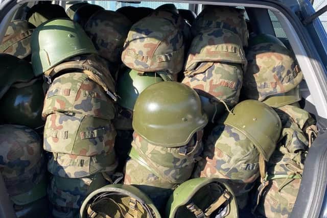 Military helmets are packed into a car before being transported to Ukraine.