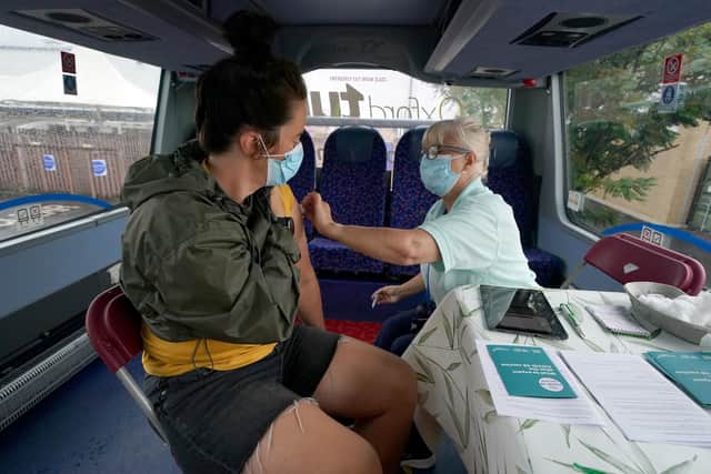 Covid Vaccinator Carole Venters gives a first vaccination to Holly Aiken on board a covid vaccination bus at the Forge Shopping Centre in Glasgow. (Photo: Andrew Milligan/PA Wire).