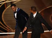 Smith (R) slaps US actor Chris Rock onstage during the 94th Oscars at the Dolby Theatre in Hollywood, California