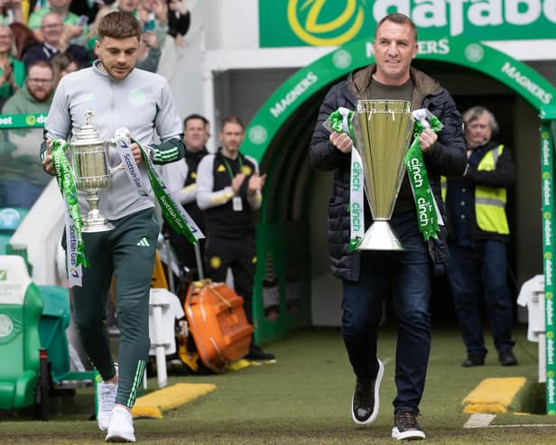 Celtic manager Brendan Rodgers and James Forrest bring out the cinch Premiership trophy and the Scottish Cup.