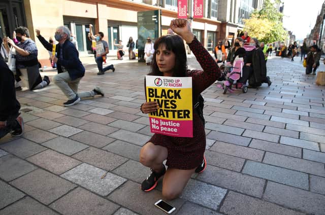 Demonstrators take a knee for George Floyd during a Black Lives Matter protest rally in Glasgow organised by Stand Up To Racism Scotland (Picture: Andrew Milligan/PA)