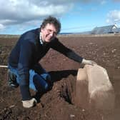 Chris Gee of the Archaeology Institute at University of Highlands and Islands with the quernstone, which was used to grind corn. The find adds more evidence to the belief that a settlement could have been made here between 3600-3200BC, hundreds of years before the world-famous Skara Brae. PIC: UHI Archaeology Institute.
