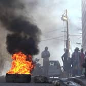 Tyres are on fire near the main prison of Port-au-Prince, Haiti, after a breakout by several thousand inmates. At least a dozen people died as gang members attacked the main prison in Haiti's capital, triggering a breakout by several thousand inmates. Picture: AFP via Getty Images
