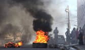 Tyres are on fire near the main prison of Port-au-Prince, Haiti, after a breakout by several thousand inmates. At least a dozen people died as gang members attacked the main prison in Haiti's capital, triggering a breakout by several thousand inmates. Picture: AFP via Getty Images