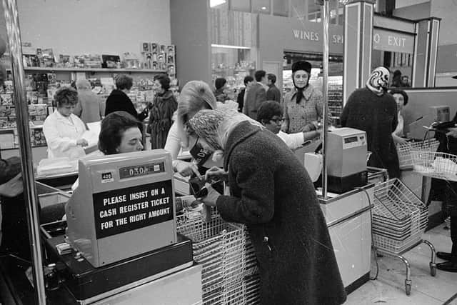 An assistant helps an elderly customer pay for her purchases using the new decimal coinage in a London supermarket on the first day of national decimalisation (Photo: Leonard Burt/Central Press/Getty Images)