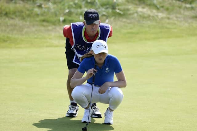 Louise Duncan lines up a putt with her caddie/mentor Dean Robertson during the AIG Women's Open at Carnoustie. Pictrure: Ian Rutherford/PA Wire.