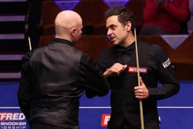 Ronnie O'Sullivan (right) bumps elbows with Anthony McGill after the Scot's victory at the Betfred World Snooker Championships at the Crucible. Picture: George Wood/PA Wire