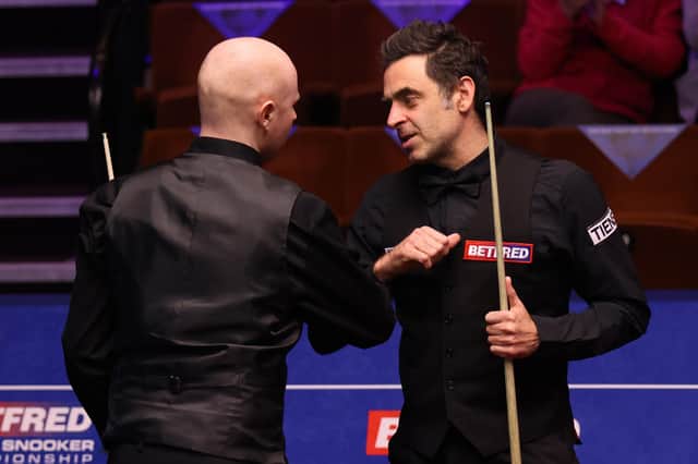 Ronnie O'Sullivan (right) bumps elbows with Anthony McGill after the Scot's victory at the Betfred World Snooker Championships at the Crucible. Picture: George Wood/PA Wire