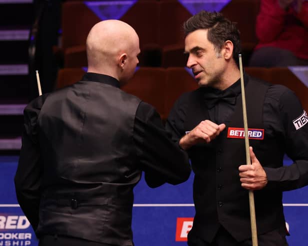 Ronnie O'Sullivan (right) bumps elbows with Anthony McGill after the Scot's victory at the Betfred World Snooker Championships at the Crucible. Picture: George Wood/PA Wire