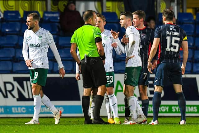 Hibs' Christian Doidge walks off after being shown a red card by referee Gavin Duncan. (Photo by Ross MacDonald / SNS Group)