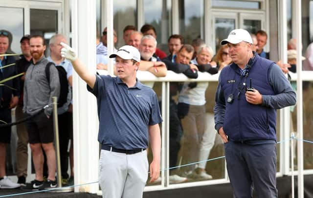 Bob MacIntyre gets a ruling during the second round of the Genesis Scottish Open at The Renaissance Club in East Lothian. Picture: Andrew Redington/Getty Images.