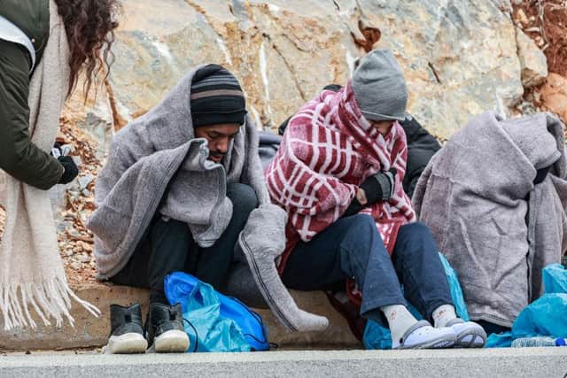 Asylum seekers receive treatment from NGO workers, in Thermi on the Greek island of Lesbos in February this year.