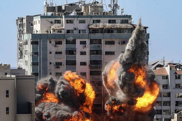 A ball of fire erupts from the Jala Tower as it is destroyed in an Israeli airstrike in Gaza City.
