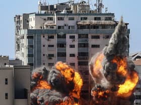 A ball of fire erupts from the Jala Tower as it is destroyed in an Israeli airstrike in Gaza City.