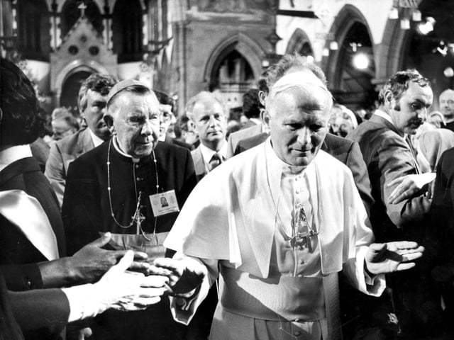 His Holiness the Pope walks through the congregation in St Mary's RC Cathedral in Broughton Place, with Cardinal Gordon Joseph Gray in the background.