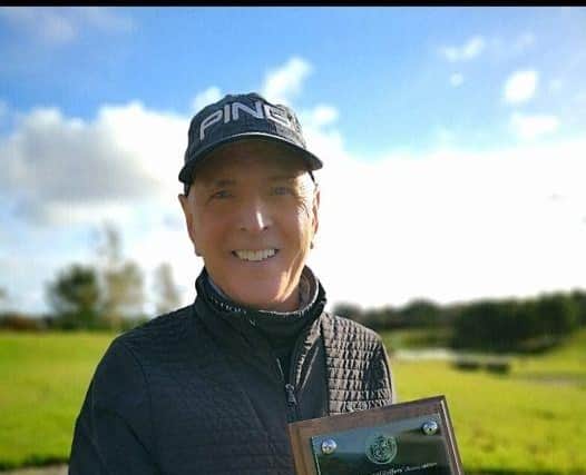 Ronnie McDonald shows off his plaque commemorating 50 years' service as a PGA Professional. Picture: Newmachar Golf Club