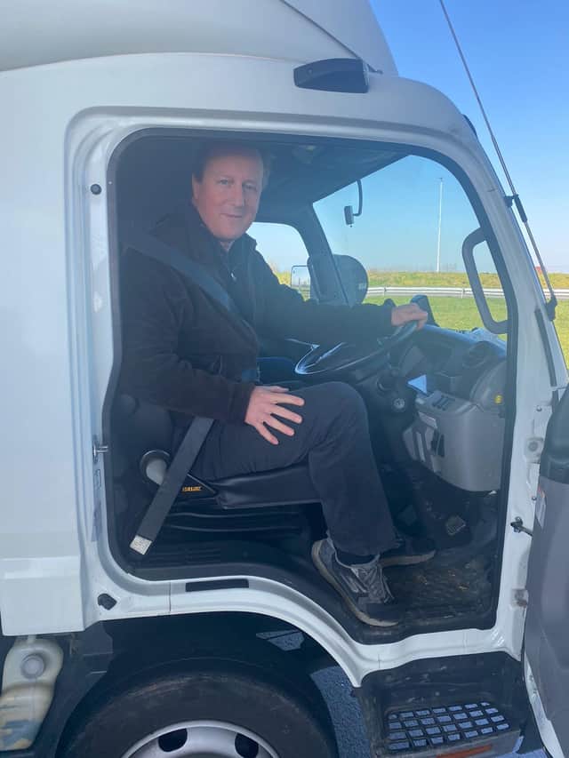 David Cameron is driving a small lorry of supplies to Poland