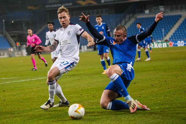 Scott Arfield in action during Rangers' 2-0 win against Lech Poznan, with Vasyl Kravets in hot pursuit