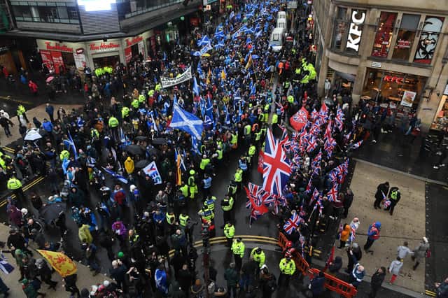Independence supporters march by a unionist counter-demonstration in Glasgow (Picture: Andy Buchanan/AFP via Getty Images)