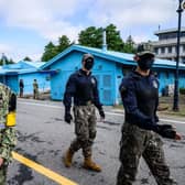 A United Nations Command soldier and South Korean soldiers walk in the Joint Security Area of the Demilitarized Zone in the truce village of Panmunjom. North Korea fired a mid-range ballistic missile on October 4, which flew over Japan, Seoul and Tokyo said, a significant escalation as Pyongyang ramps up its record-breaking weapons-testing blitz.