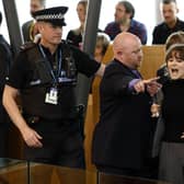 Police and security staff escort a protester from the public gallery during First Minister's Questions. Picture: Jeff J Mitchell/Getty Images