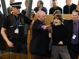 Police and security staff escort a protester from the public gallery during First Minister's Questions. Picture: Jeff J Mitchell/Getty Images