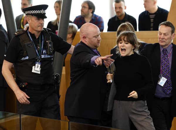 Police and security staff escort a protester from the public gallery during First Minister's Questions. Picture: Jeff J Mitchell/Getty Images