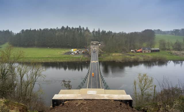A worker walks across the Union Chain Bridge which is set to officially reopen next week. Picture: Phil Wilkinson