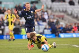 Kye Francis Rowles of the Mariners brings down Benjamin Old of Phoenix in the penalty area during the A-League match between Wellington Phoenix and Central Coast Mariners at WIN Stadium, on November 27, 2021, in Wollongong, Australia. (Photo by Mark Evans/Getty Images)