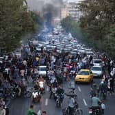 Protesters take to the streets of Iran's capital Tehran following the death of Mahsa Amini in 'morality police' custody (Picture: AFP via Getty Images)