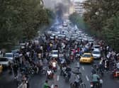 Protesters take to the streets of Iran's capital Tehran following the death of Mahsa Amini in 'morality police' custody (Picture: AFP via Getty Images)