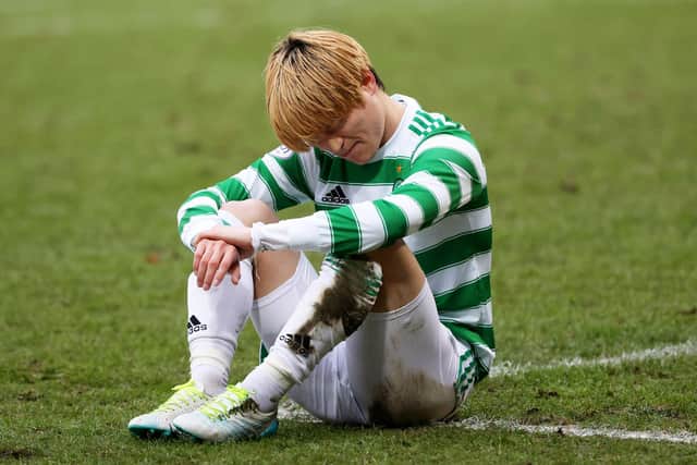 Celtic's Kyogo Furuhashi suffers an injury at McDiarmid Park.