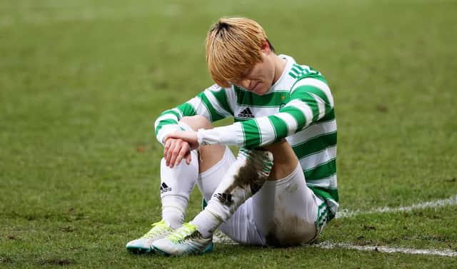 Celtic's Kyogo Furuhashi suffers an injury at McDiarmid Park.