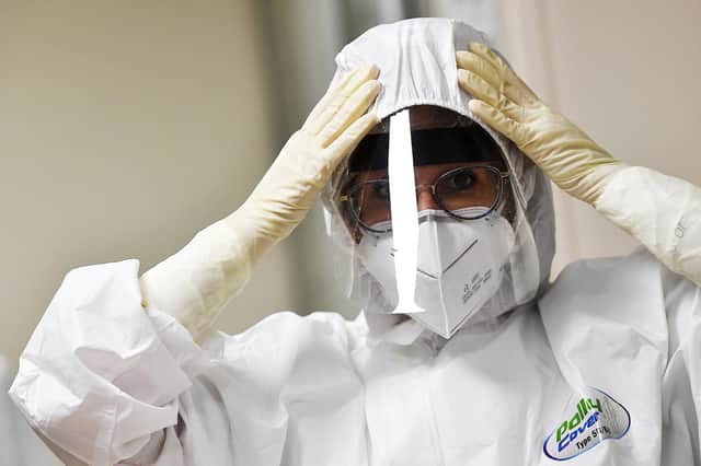 A nurse puts on PPE at an intensive care unit. Picture: Tiziana Fabi via Getty Images