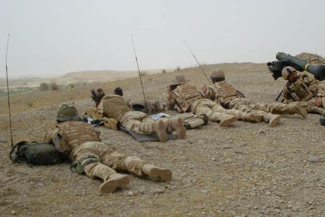 Former Royal Marine Dickie Bennett (second from left) on patrol in Afghanistan. He was medically discharged in 2011 after being injured in both a vehicle collision and by an anti-personnel land mine.