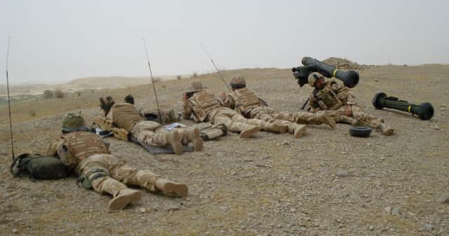 Former Royal Marine Dickie Bennett (second from left) on patrol in Afghanistan. He was medically discharged in 2011 after being injured in both a vehicle collision and by an anti-personnel land mine.