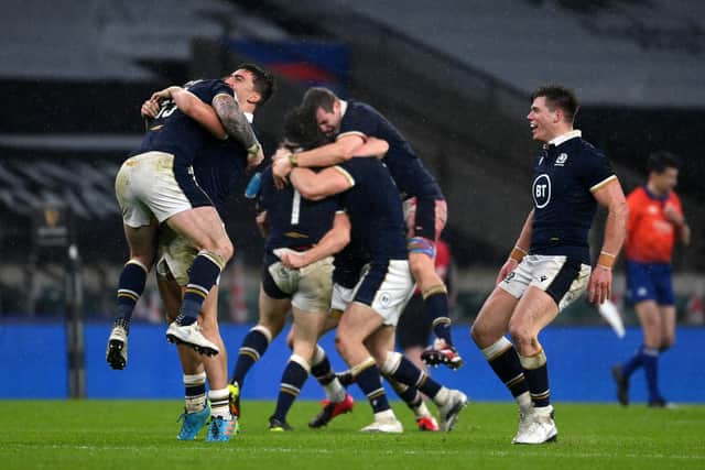 Stuart Hogg, Cameron Redpath and Huw Jones of Scotland celebrate following their side's victory after the Guinness Six Nations match between England and Scotland at Twickenham Stadium on February 06, 2021 in London, England.  (Photo by Mike Hewitt/Getty Images)