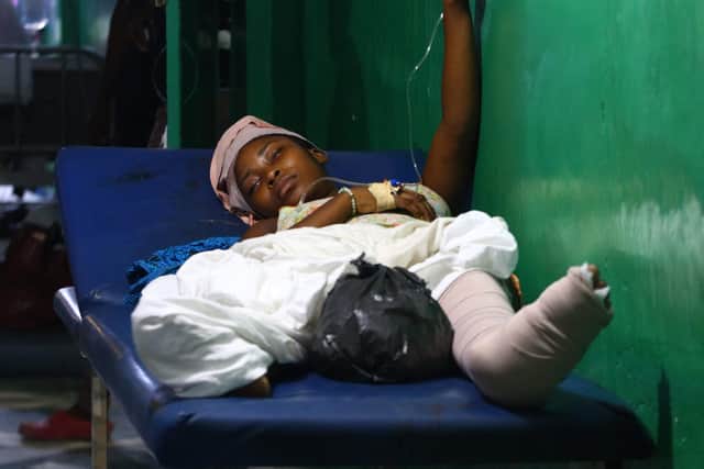 An earthquake victim lies on a stretcher at the Cayes General Hospital on August 14, 2021 in Les Cayes, southwest Haiti. Picture: Stanley Louis/AFP via Getty Images