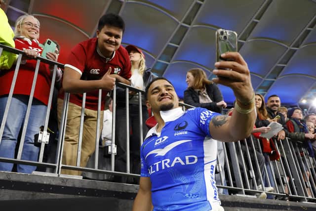 Sione Tuipulotu, wearing a Western Force jersey, takes a selfie with the fans after the Lions' win in Perth. (Photo by James Worsfold/Getty Images)