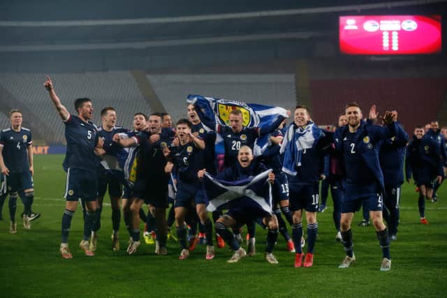 The Scotland players celebrate their Euros playoff triumph, just before getting stuck into Yes Sir, I Can Boogie (Picture: Srdjan Stevanovic/Getty Images)