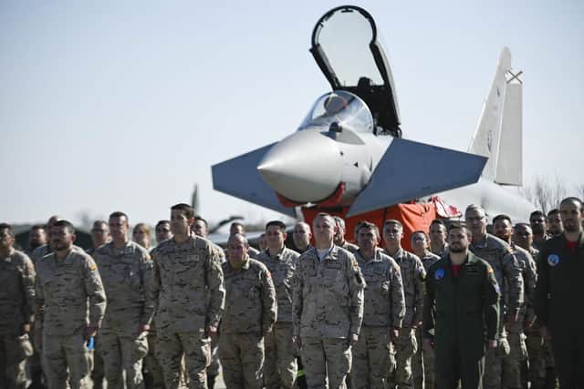 Spanish pilots and soldiers stand in front of a Spanish Eurofighter EF-2000 Typhoon II aircraft during the visit of the Spanish Defence Minister Margarita Robles at Graf Ignatievo airbase near Plovdiv on February 21, 2022. Spain has deployed four fighter jets to fellow NATO member Bulgaria. Photo: Nikolay DOYCHINOV / AFP.