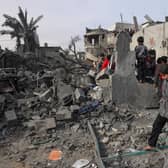 Palestinians inpect the damage in the rubble of a building where two hostages were reportedly held before being rescued during an operation by Israeli security forcess in Rafah, on the southern Gaza Strip. Picture: Said Khatib/AFP via Getty Images