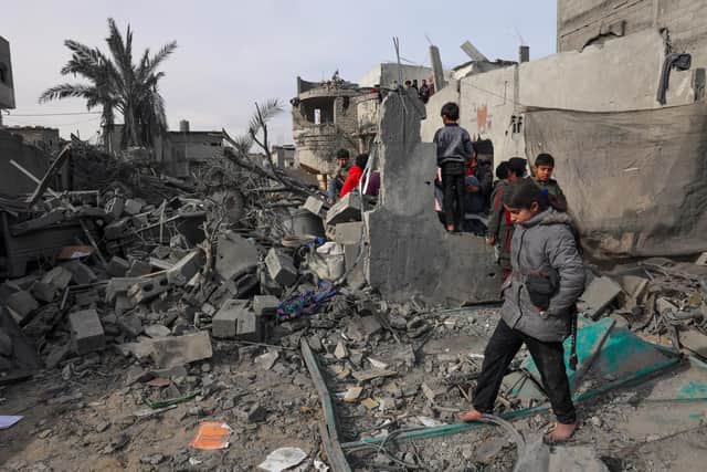 Palestinians inpect the damage in the rubble of a building where two hostages were reportedly held before being rescued during an operation by Israeli security forcess in Rafah, on the southern Gaza Strip. Picture: Said Khatib/AFP via Getty Images