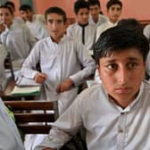 Rizwan Ullah, a survivor of the cable car accident sits in a classroom at a school in the Pashto village of mountainous Khyber Pakhtunkhwa province a day after being rescued from a chairlift which dangled over a ravine for 15 hours.
